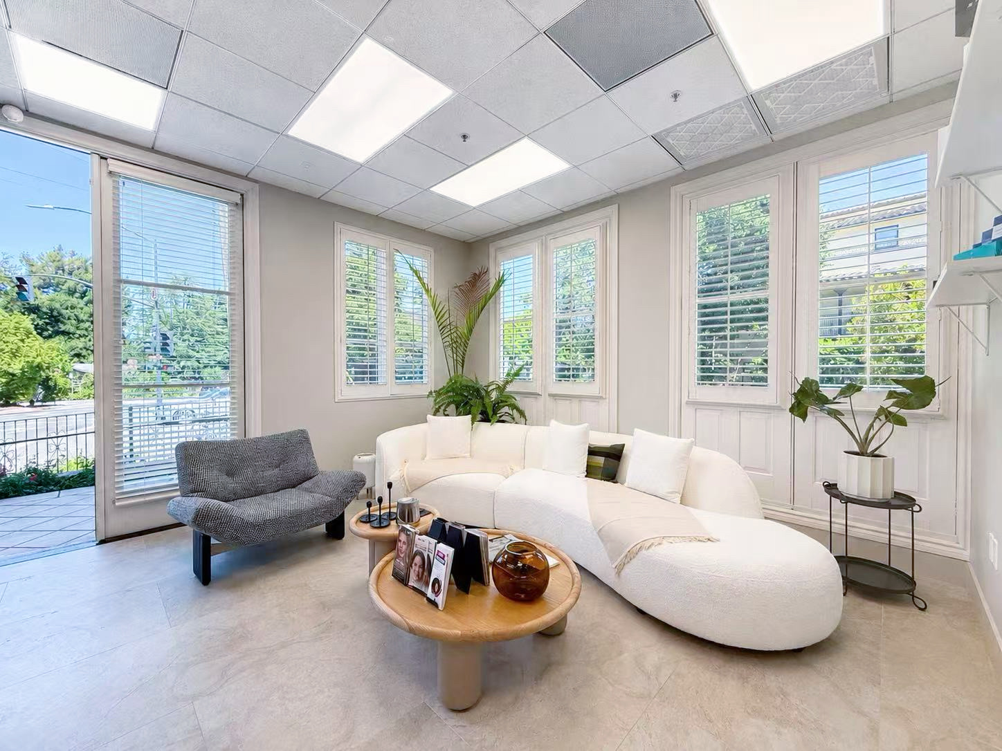 Los Altos clinic lounge with curved sofa and shuttered windows